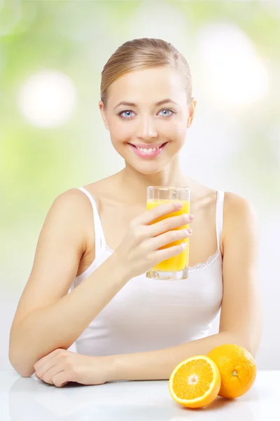 Smiling girl with orange juice