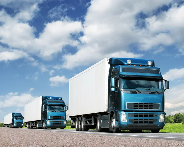 Convoy of trucks on highway, cargo transportation concept