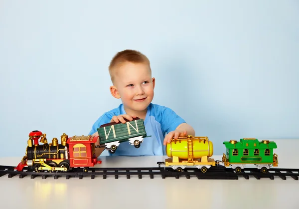 Boy playing with toy railroad