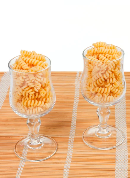 Macaroniin a glass on a straw mat