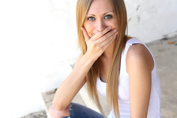 Young blonde woman making funny faces