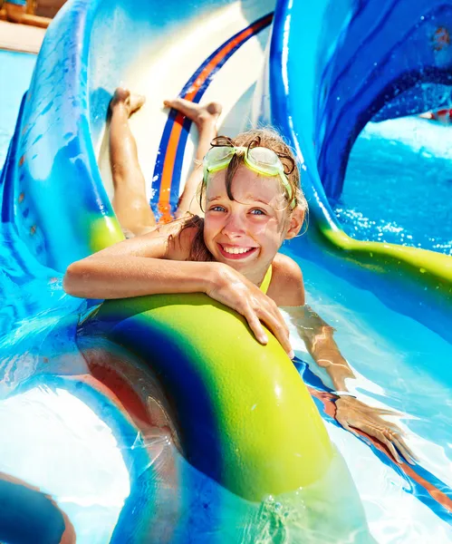 Child on water slide at aquapark. Summer holiday. — Stock Photo #9871150