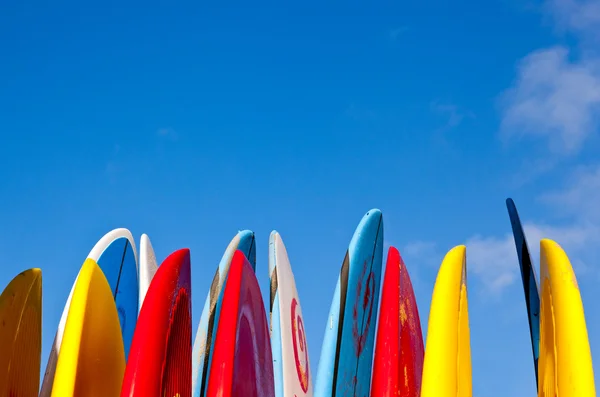 Stack of surfboards by seaside