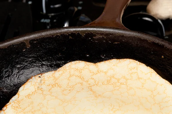 Cooking pancake mix into frying pan — Stock Photo #9135586