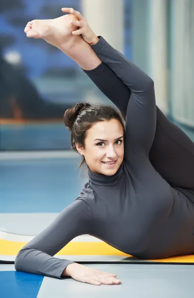 Happy smiling woman at gymnastic fitness exercise