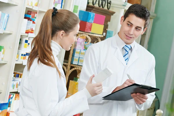 Two Pharmacy chemist workers in drugstore