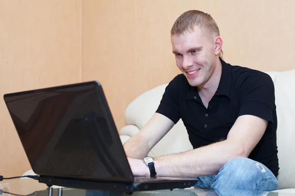 Young man playing in games on laptop
