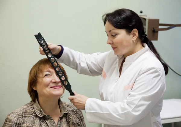 Ophthalmologist and patient testing eyesight
