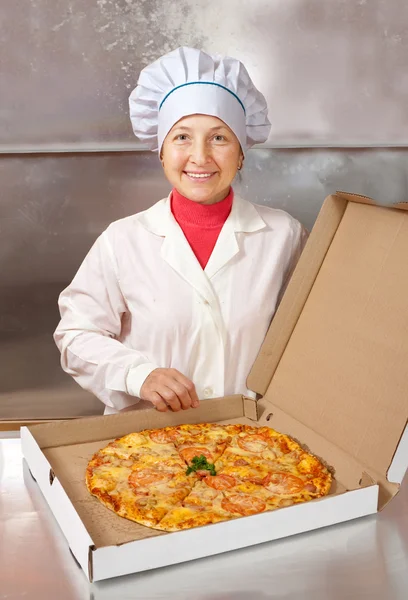 Female cook with cooked pizza