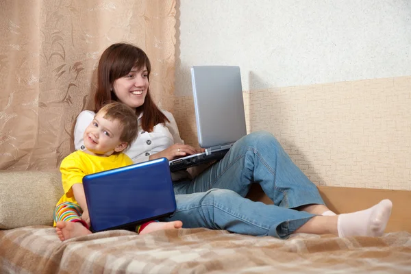 Happy woman and child with laptops