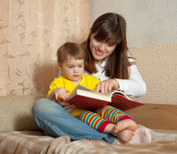 Mother showing book to her baby