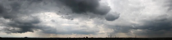 Dark rain clouds over the city, panorama