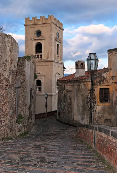 Paved medieval street with belfry in Savoca village, Sicily