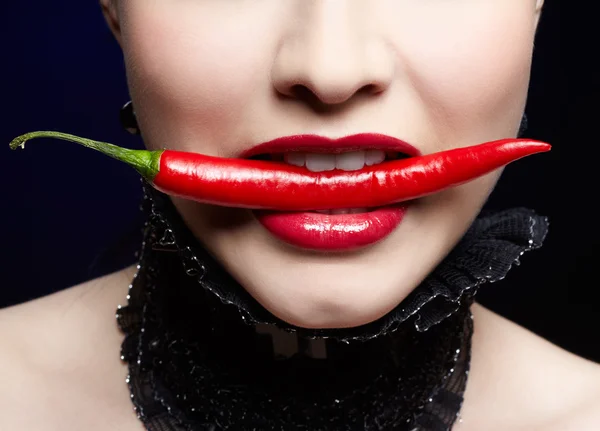 Beautiful girl with red chilli pepper