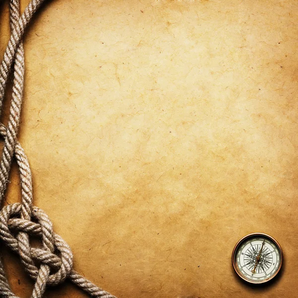 Compass and rope on grunge background
