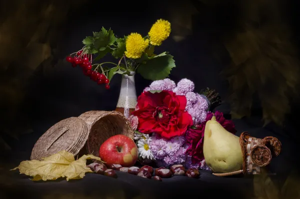 Still life with autumn fruits and flowers on black background