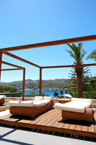Modern hut and sunbeds at luxury hotel, Crete, Greece