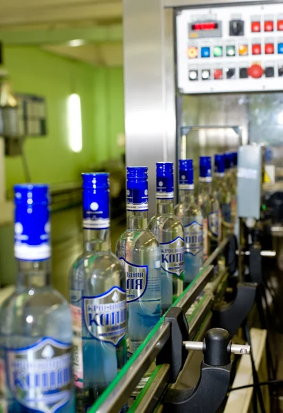 Bottles of alcohol drinks on conveyor