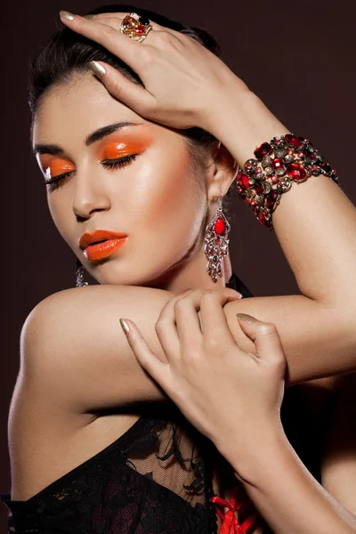 Elegant fashionable woman with red jewelry