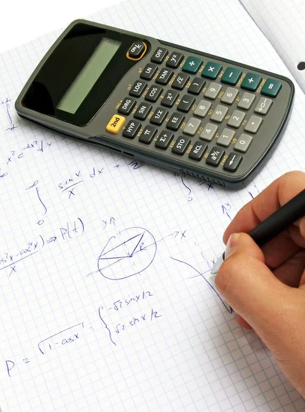 Scientific calculator on notebook paper — Stock Photo #8510552