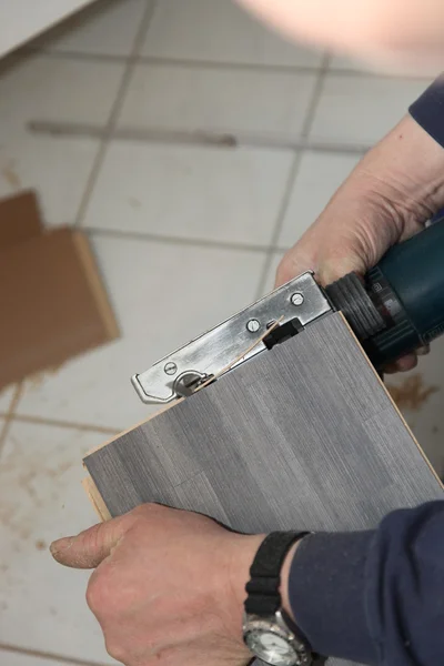 Handyman trimming tiles