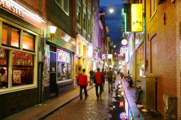 Bars and coffee shops on the night streets of Amsterdam.