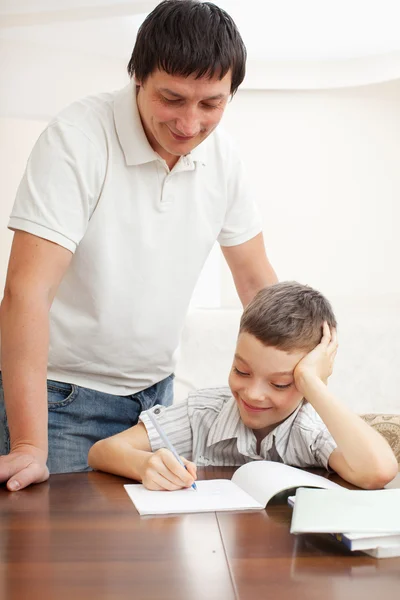 Father helping son do homework