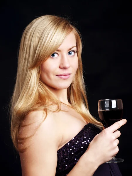 Young woman with champagne over dark background