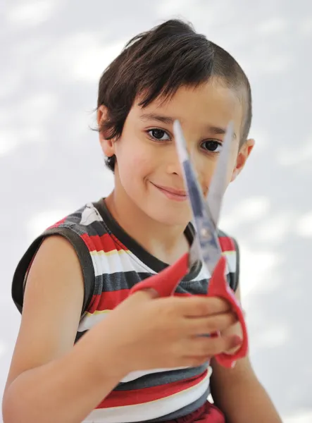 Kid cutting hair to himself with scissors, funny look