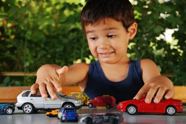 Children playing with cars toys outdoor in summer time