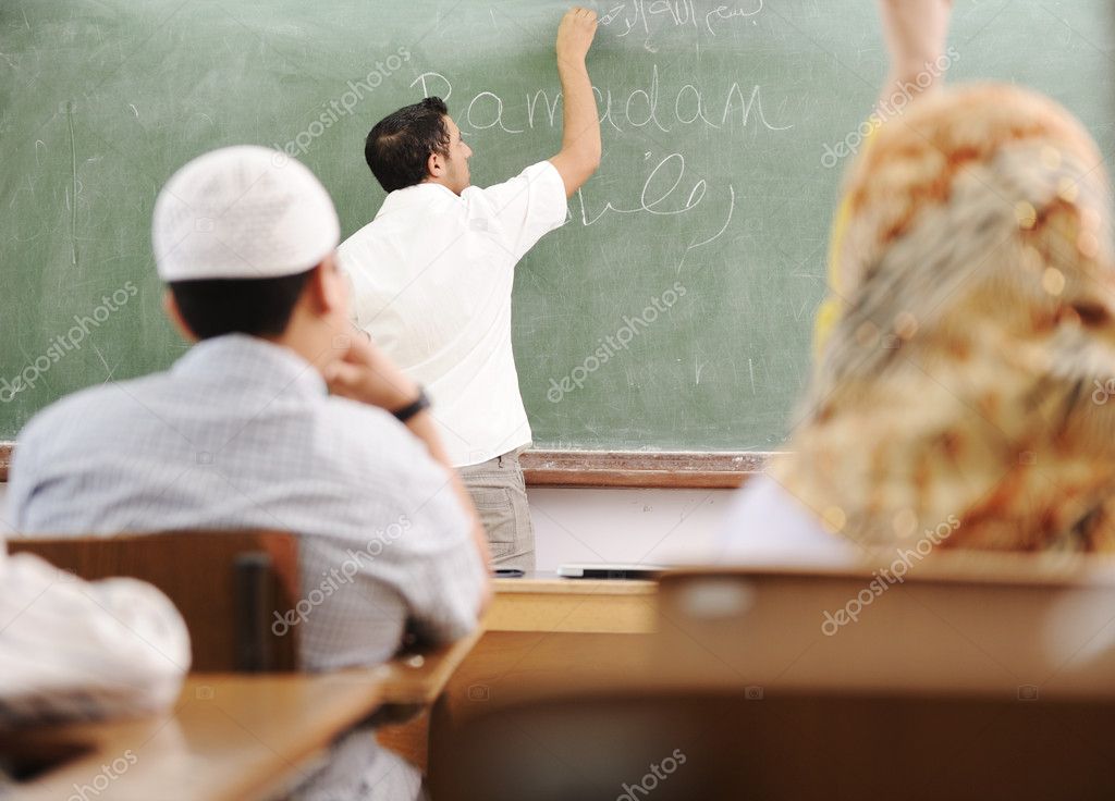 muslim-arabic-teacher-writing-on-board-stock-photo-zurijeta-8843818