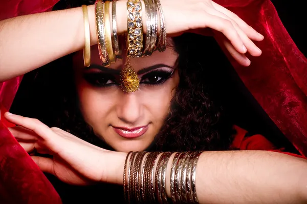 Beautiful young woman in color arabian clothes