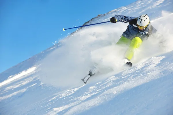 Skiing on fresh snow at winter season at beautiful sunny day