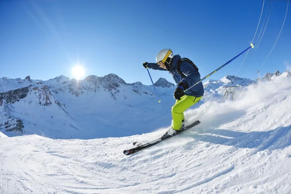 Skiing on fresh snow at winter season at beautiful sunny day