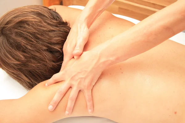 Massage of male back and shoulders