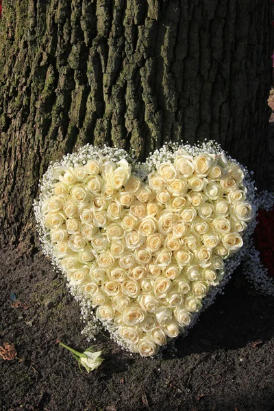 Heart shaped sympathy flower arrangement, white roses