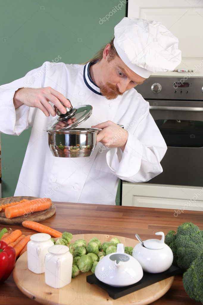 Funny young chef strange looking at pot — Stock Photo © vladacanon 9059353