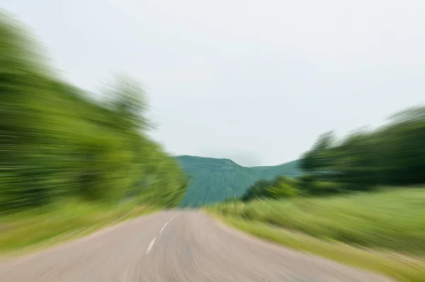 Country road and hill in motion