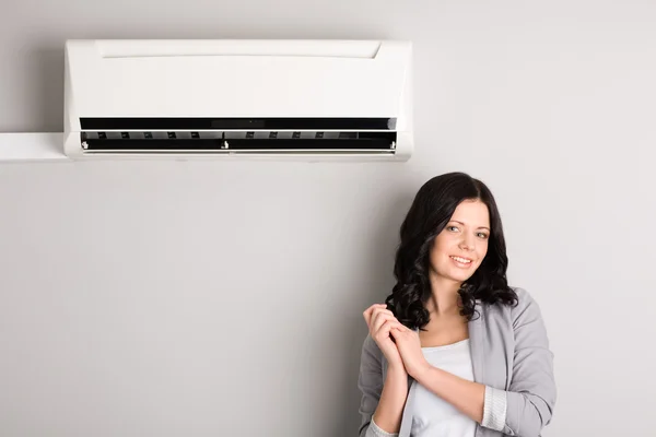 Beautiful girl and air conditioner