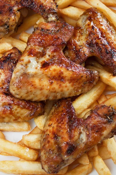 Grilled chicken wings with french fries