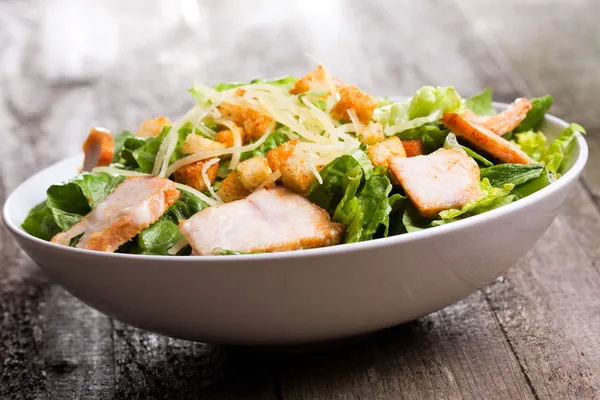 Caesar salad with chicken and greens