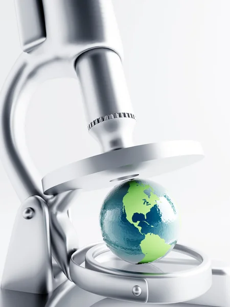 Researching of earth globe under magnification with microscope