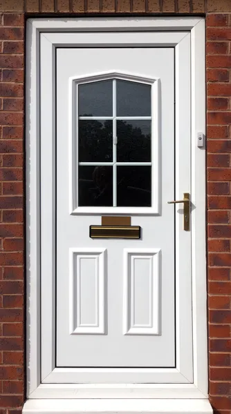 White front door in a red brick building
