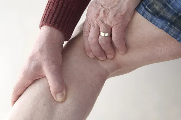 Man checks pain in his leg