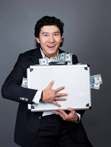 Young asian happy man with money case
