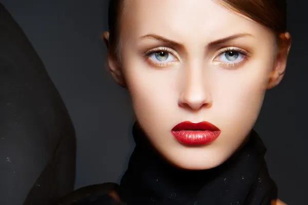 Fashion accessories. Model with chic red lips make-up. Real lights effect: mixed light with long exposure