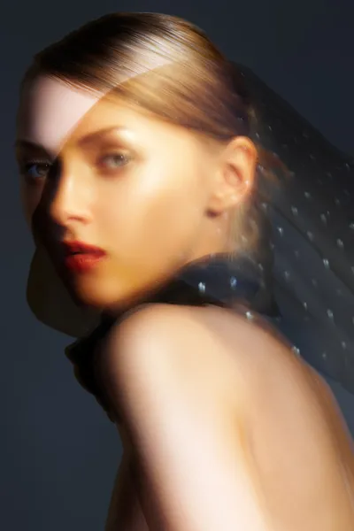 Fashion accessories. Model with chic red lips make-up. Real lights effect: mixed light with long exposure.