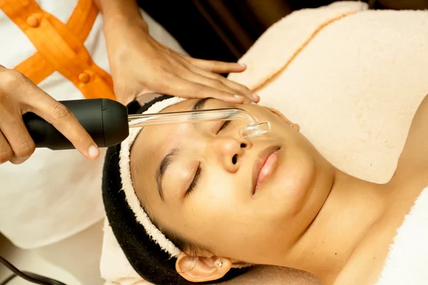 Asian young female face at facial treatment
