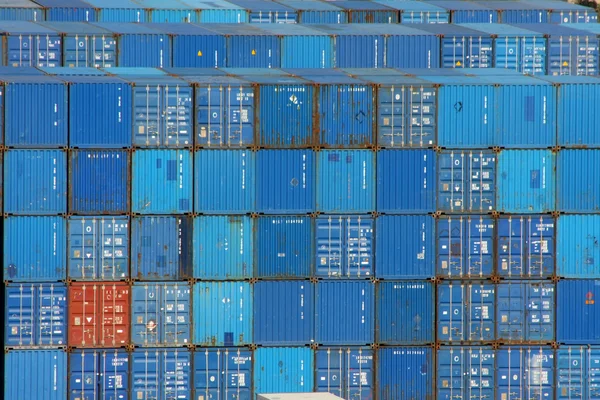 Stack of blue sea containers in an international port container shipping