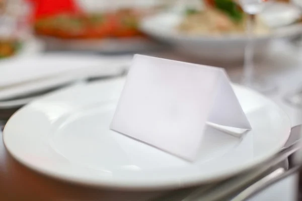 Blank plate and card for guests in restaurant